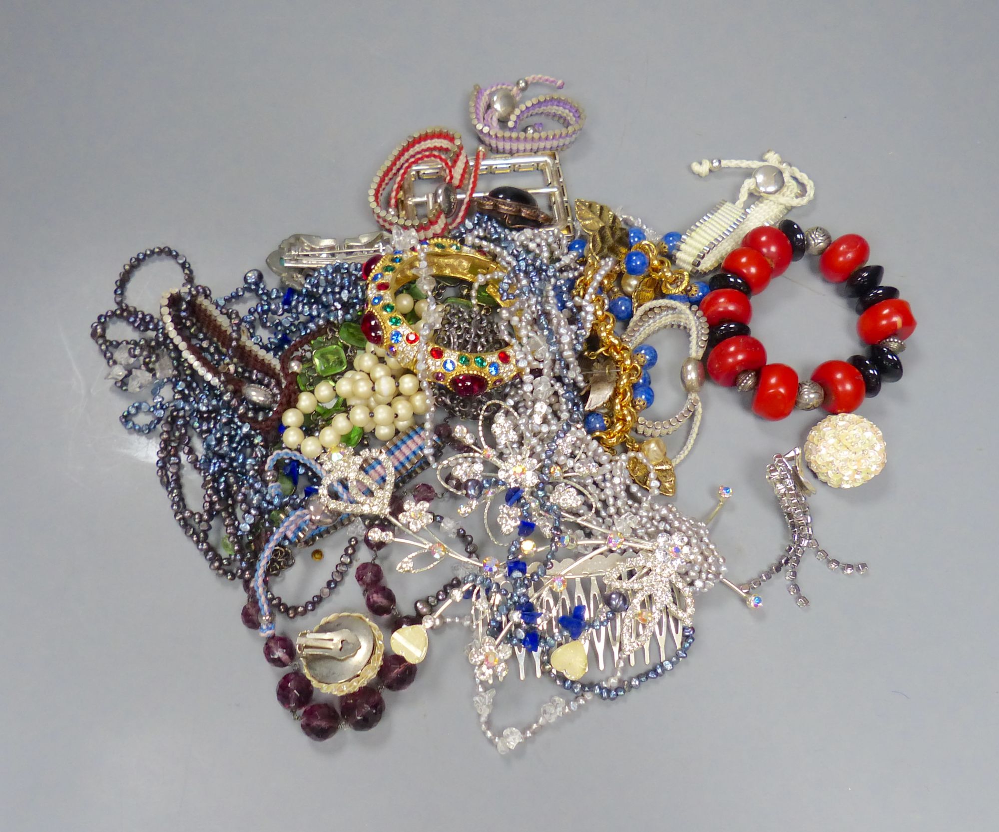 A group of assorted costume jewellery, including coloured paste necklaces.